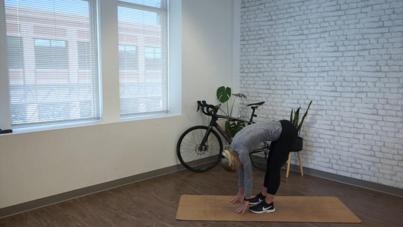 Person Stretching on A Yoga Mat Indoors