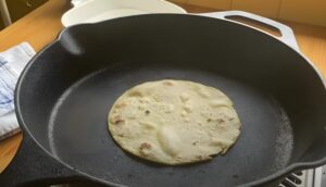 Tortilla being warmed in a skillet