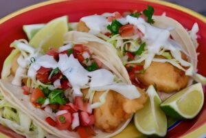 Crispy fried fish tacos, topped with creamy sauce