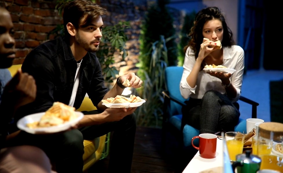 Friends eating tacos for dinner in a living room