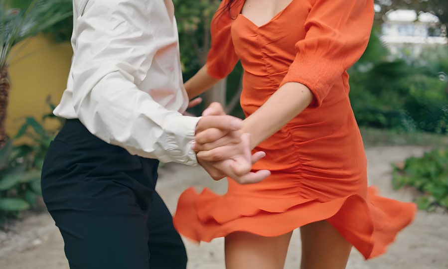 Girl dancing salsa in a red dress