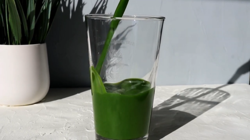 Glass with green smoothie for weight loss inside