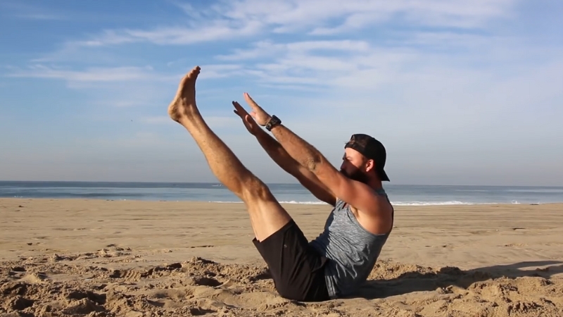 A Person Performing a Core Exercise on The Sand