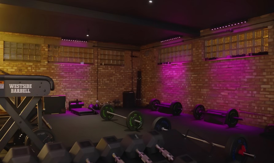 A gym room illuminated by purple lighting