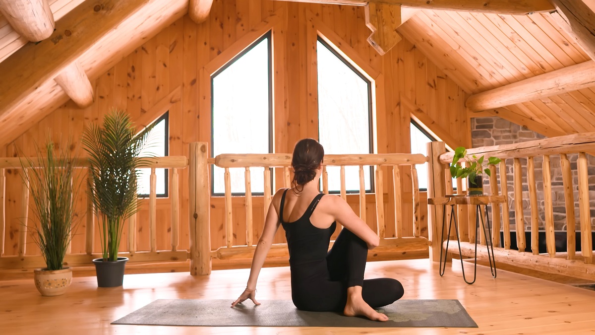 A woman perform seated spinal twist yoga pose