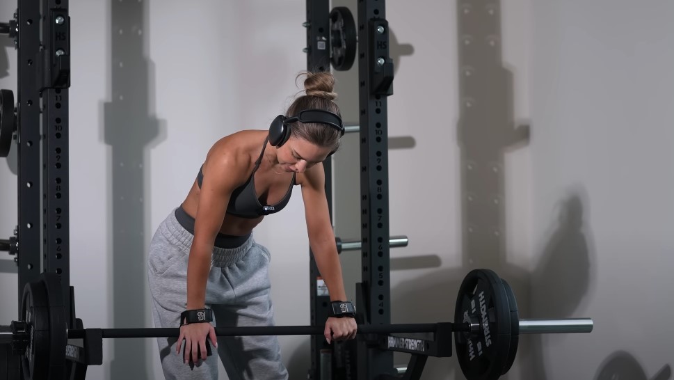 Focused lifter rests between sets, listening to music