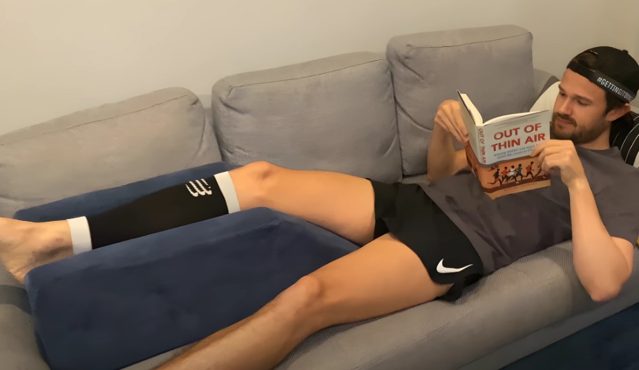 Man recovering, reading, and resting on the couch