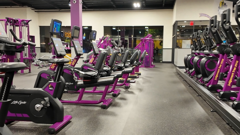 A Row of Exercise Bikes and Cardio Machines Inside a Planet Fitness Gym in California