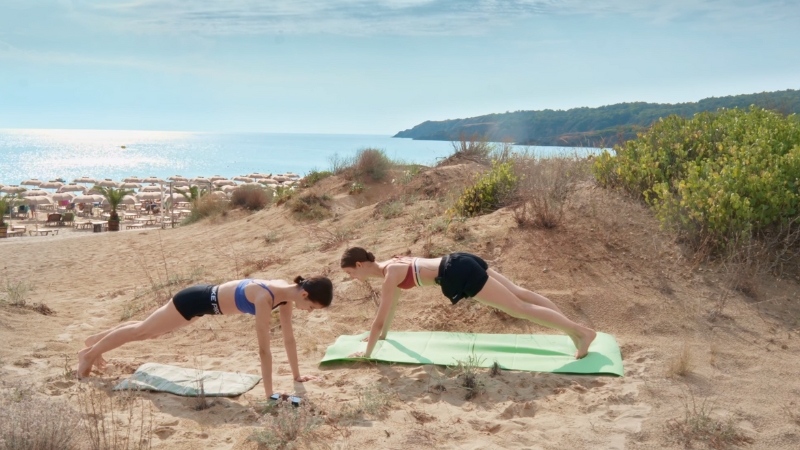 Exercising on Sand, Two People Performing Push-Ups on The Beach to Enhance Their Workout Intensity