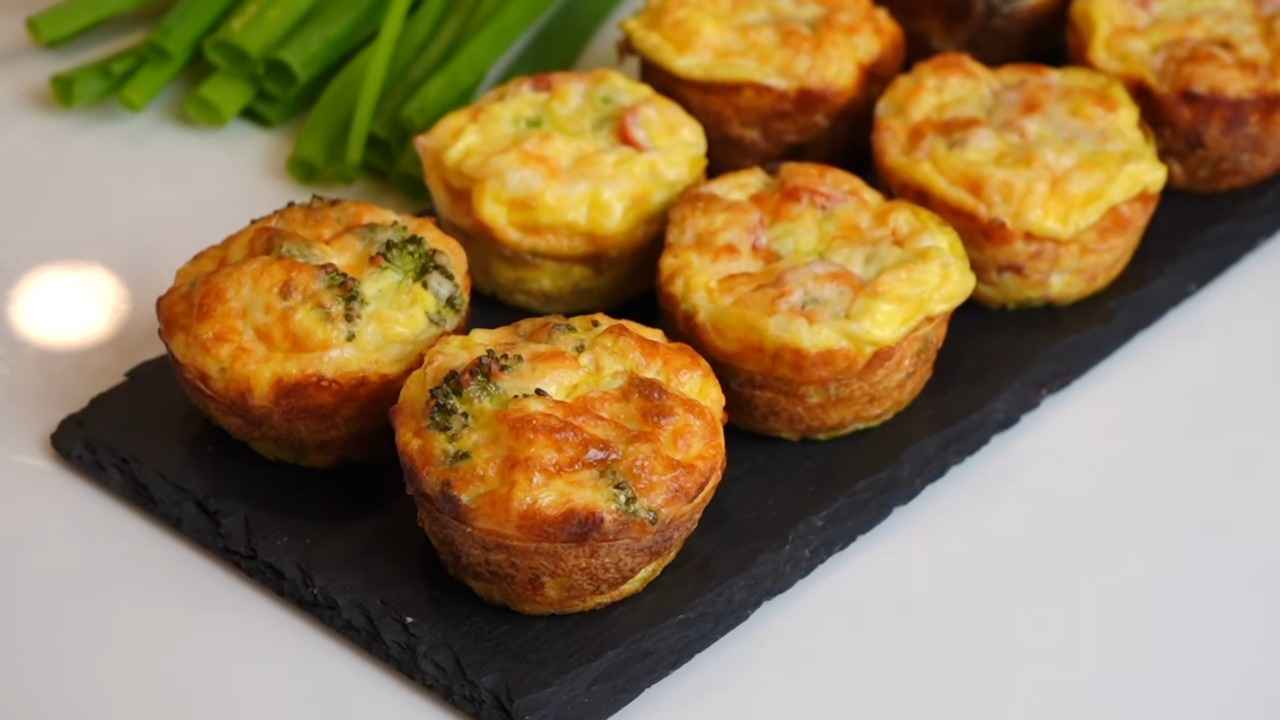 Baked egg muffins with vegetables on a slate serving tray