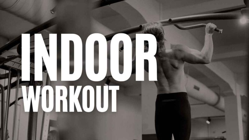 Man doing pull-ups on an indoor gym bar with “Indoor Workout” text overlay