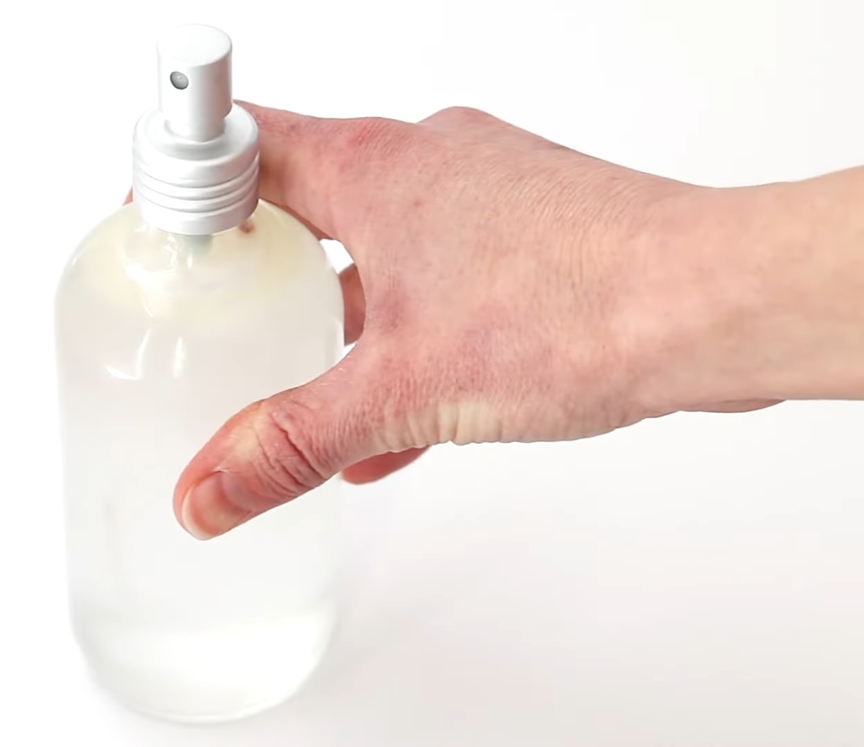 Pouring into a glass spray bottle