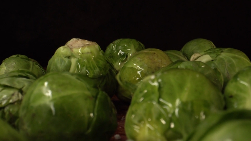 Fresh Brussels sprouts on a dark surface, packed with fiber that supports gut health and digestion