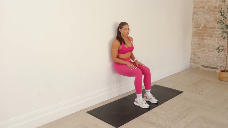 A person performing modified wall sits