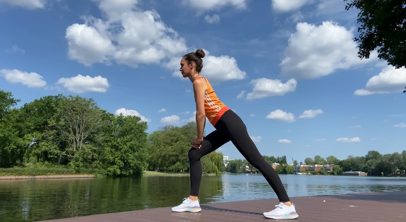 Woman stretching by the lake