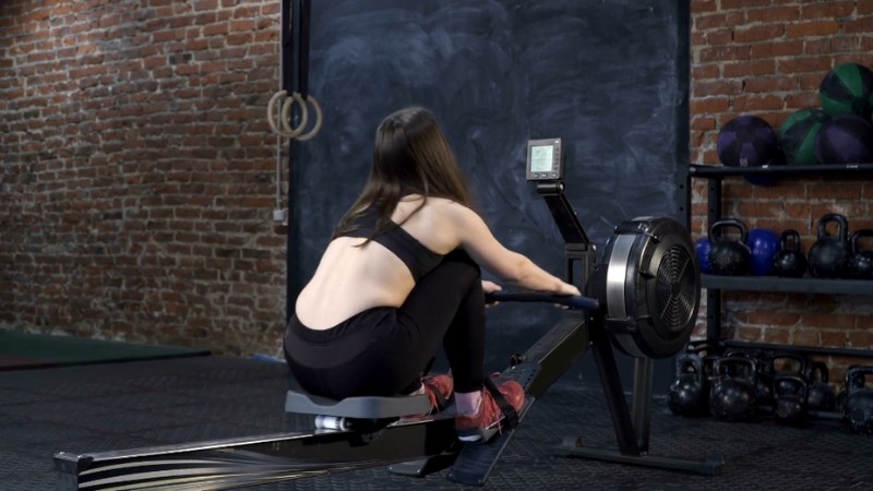 Woman on a rowing machine doing a knee-friendly workout