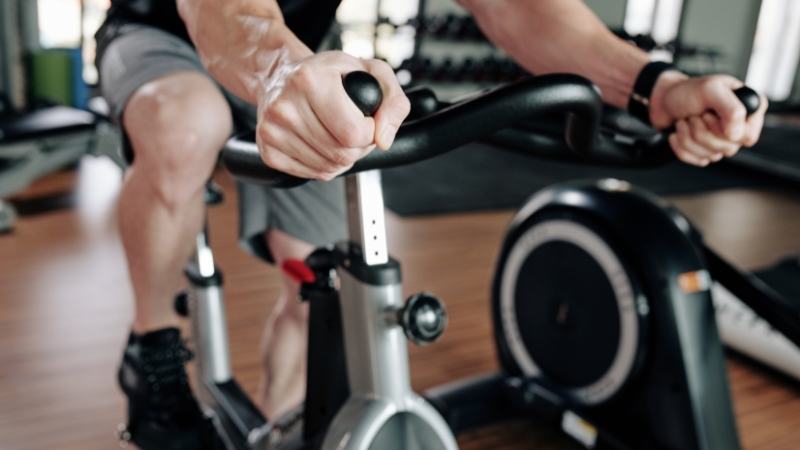 Man using a stationary bike during a moderate cardio session