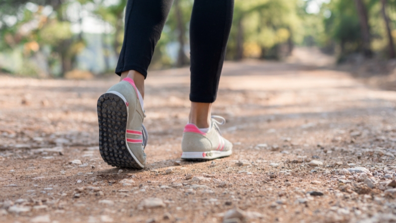 Close-up of a woman walking alone on a rocky trail