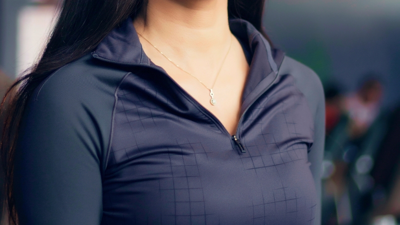 Woman wearing a lightweight, zip-up performance top