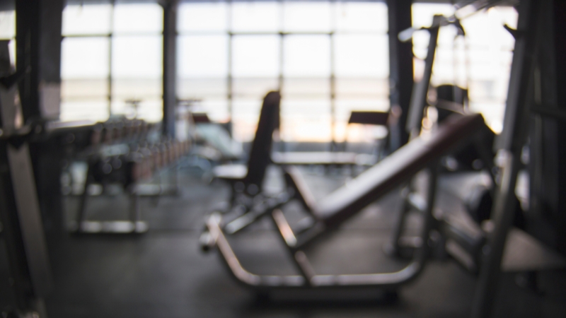 A quiet gym sits empty before sunrise, ready for early risers to start their workouts in peace