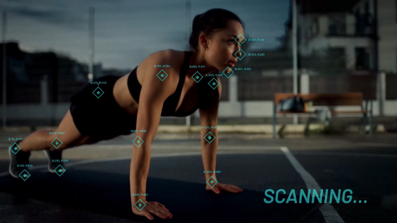 Woman in plank position monitored by AI body scan system with markers tracking movement and posture