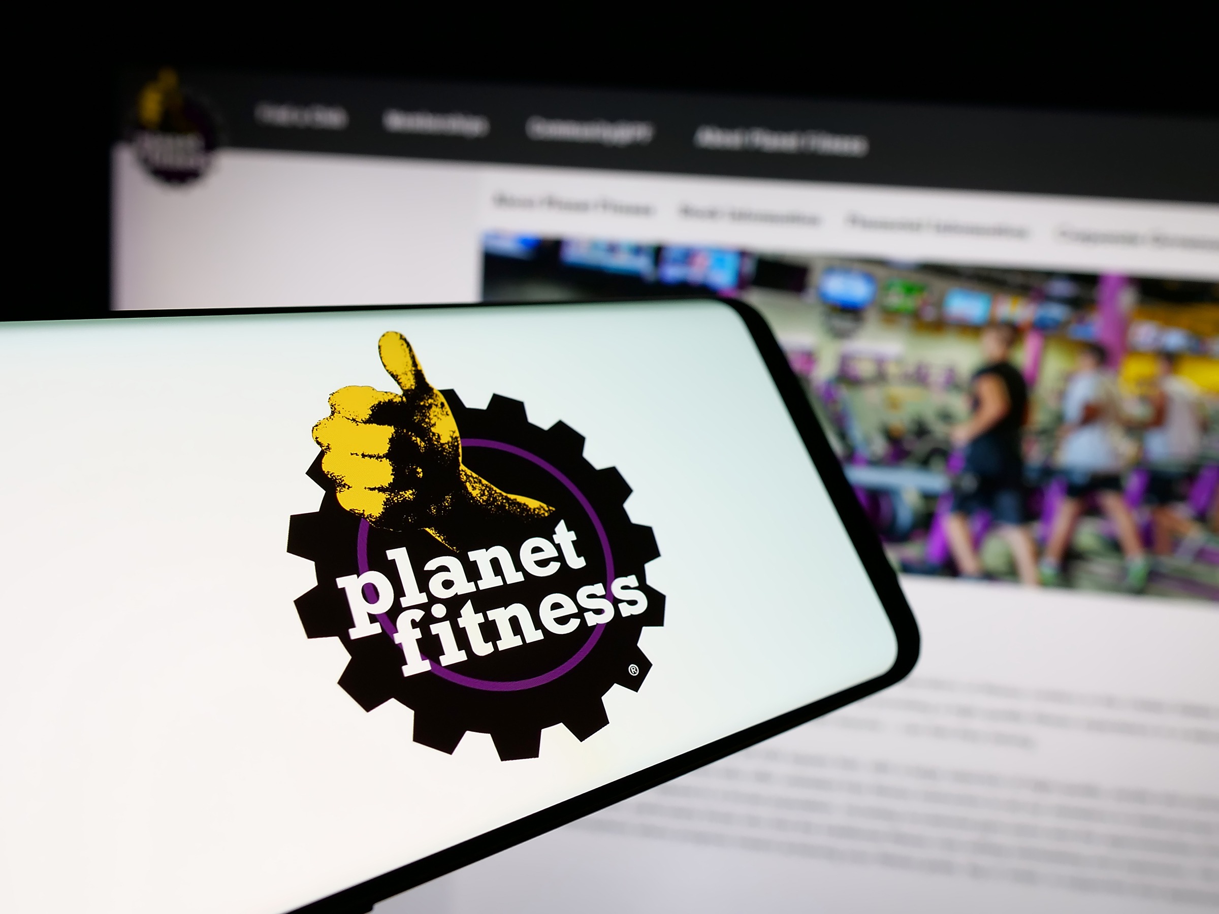 Image of a phone with a photo showing the logo of Planet Fitness