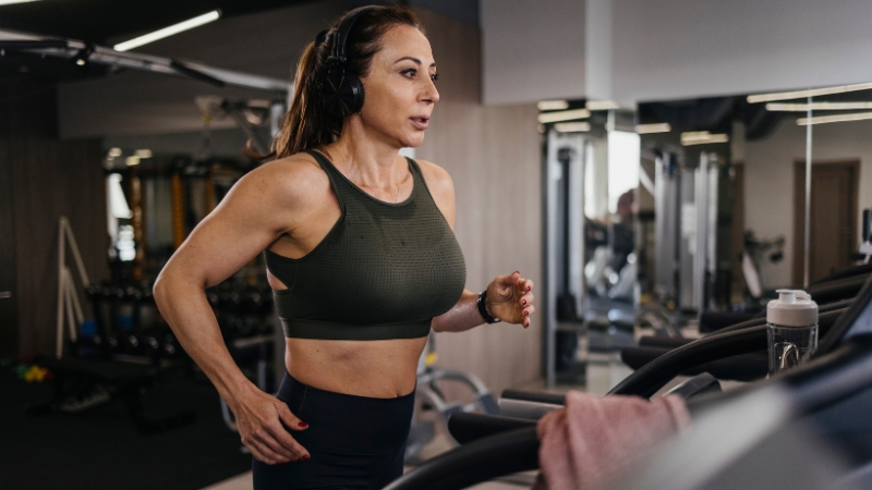 Woman running on a treadmill in a gym