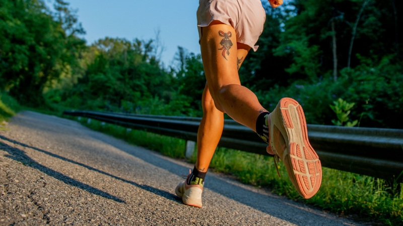 Runner on an outdoor road showing terrain challenges and skill use compared to treadmill running