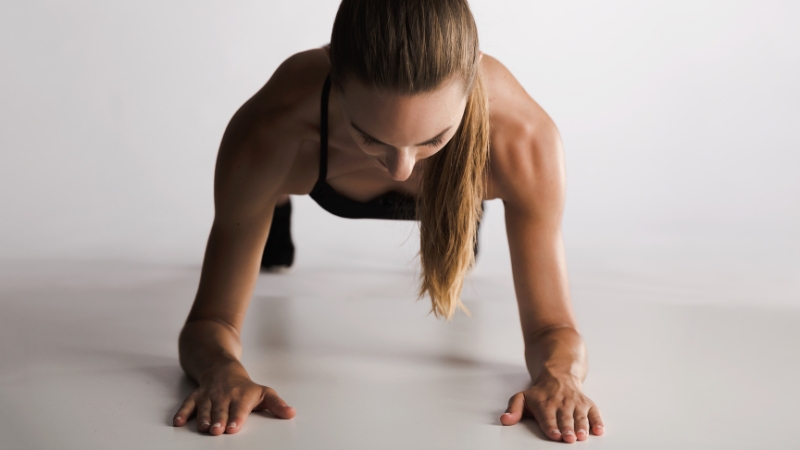 A woman holding a plank position to strengthen her core and improve stability