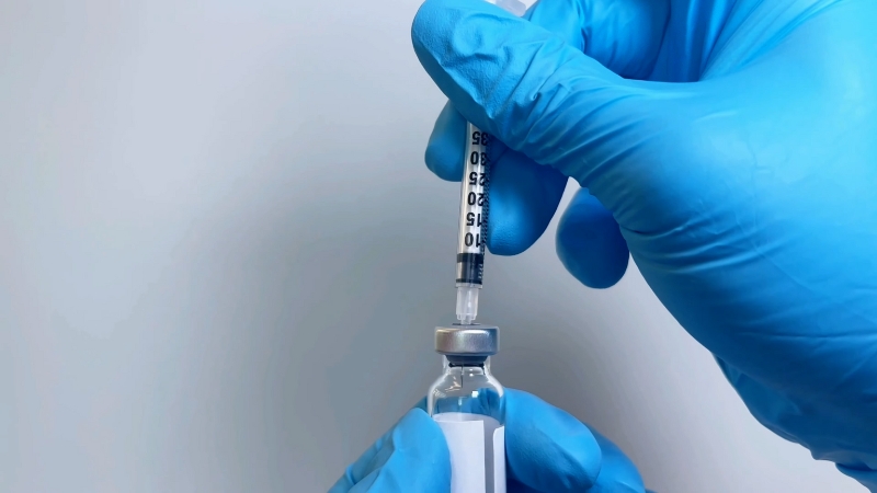 Gloved hands draw tirzepatide medication into a syringe for a low starting dose