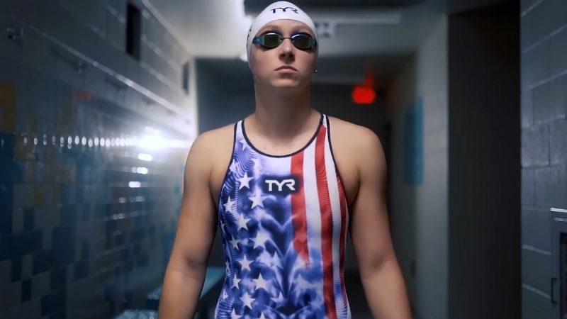 Elite swimmer in competition gear prepares for Olympic sports training before a race