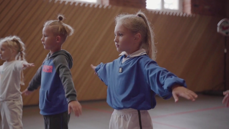 Children ages six to nine practice basic movement skills during early athletic training