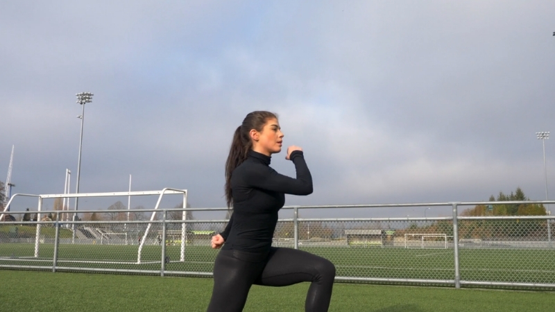 Person perform a forward lunge outdoors, target leg and glute muscles
