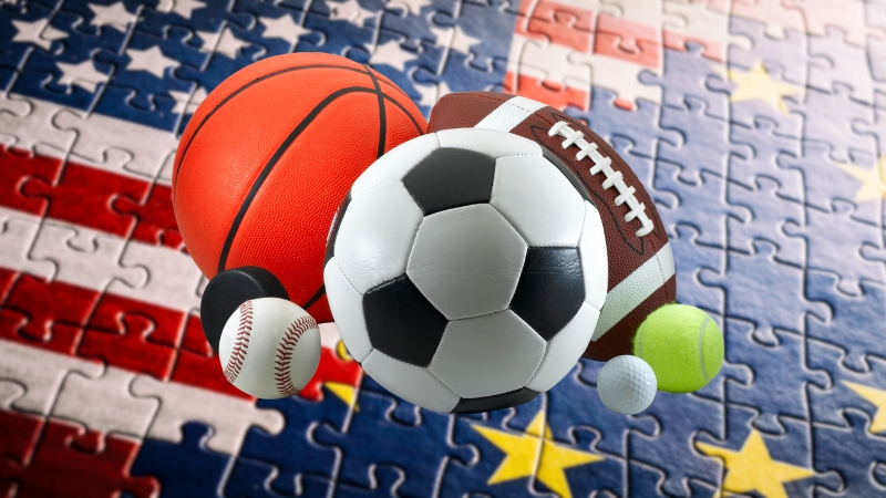 Sports balls placed over US and EU flags highlight differences in sports cultures