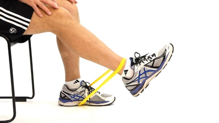 Person performs seated rehab exercises with a resistance band for leg recovery