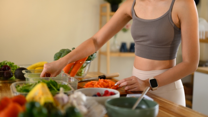 Woman preparing healthy foods that support hunger control and weight management