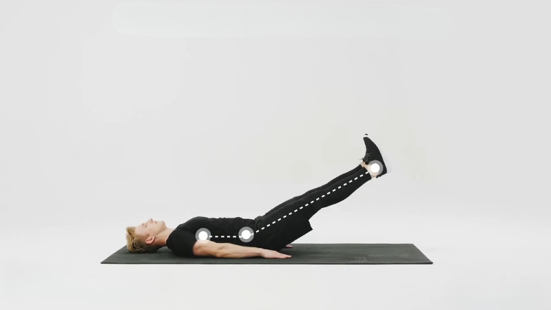 Person performs a straight leg raise exercise while lying on a mat