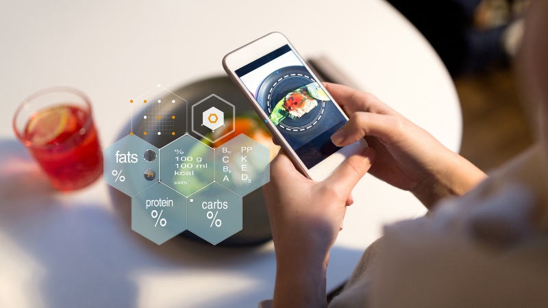 Person tracking food macros on a smartphone app to support weight loss