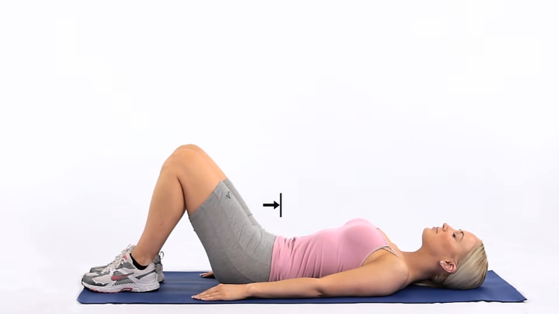 Person lies on a mat in starting position for a gentle rehab exercise