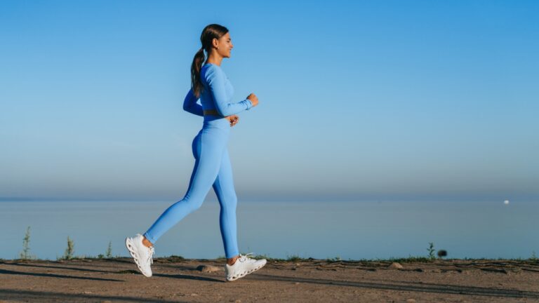 Woman walking outdoors by the water as part of an active lifestyle
