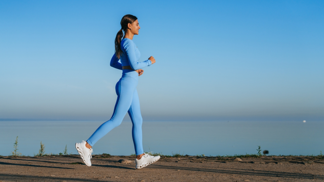 Woman walking outdoors by the water as part of an active lifestyle