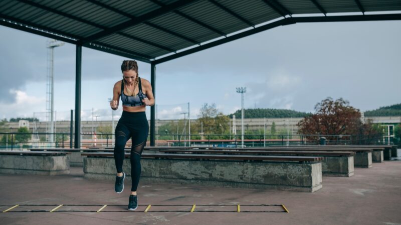 Woman doing agility ladder drills to improve speed and coordination