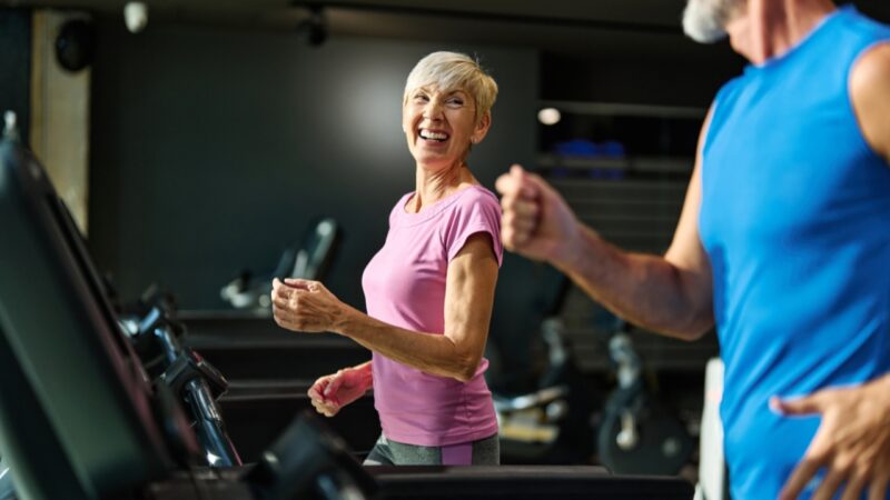 Older adults use treadmills during a light cardio workout at the gym
