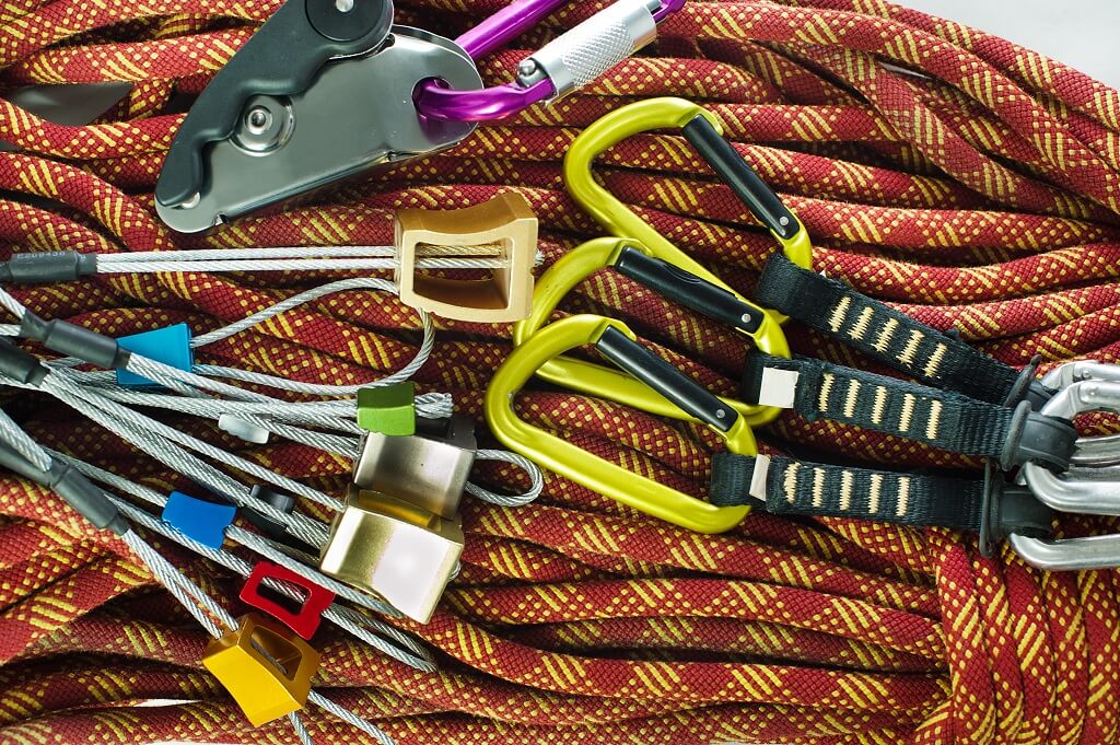 Climbing ropes, carabiners, and mountaineering gear prepared for technical mountain routes
