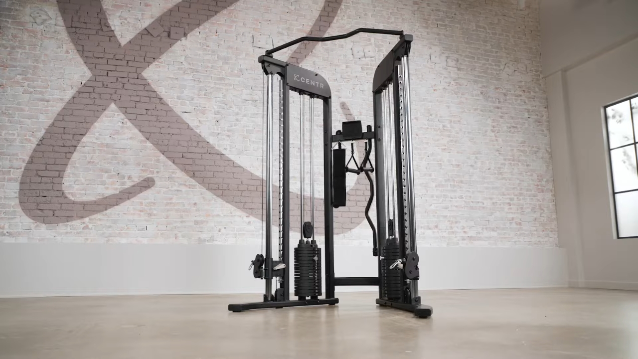 Centr functional trainer with dual weight stacks in a bright home gym